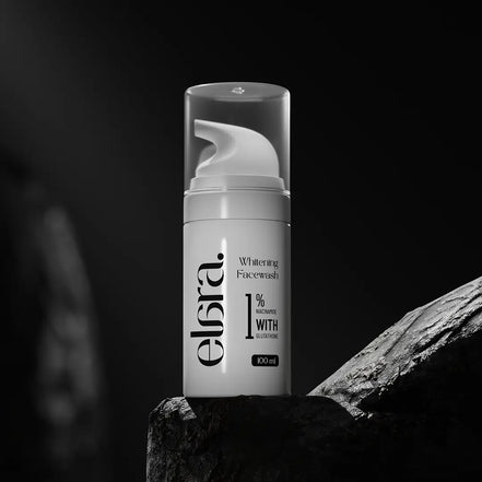 Elara whitening facewash bottle on a dark background